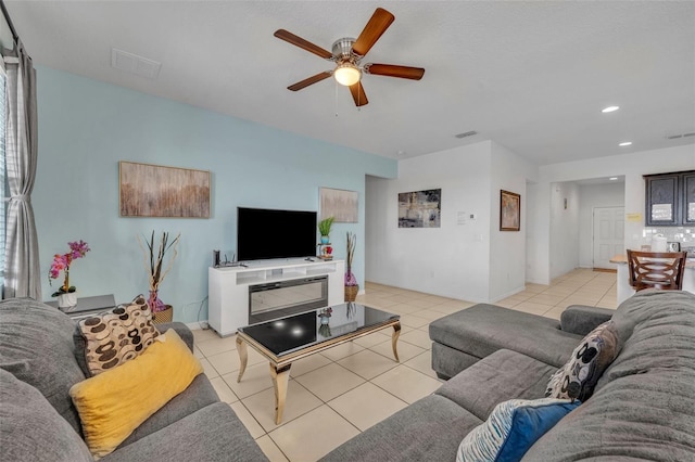 tiled living room with ceiling fan