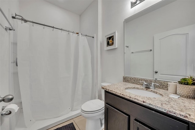 bathroom featuring toilet, a shower with curtain, tile patterned floors, and vanity