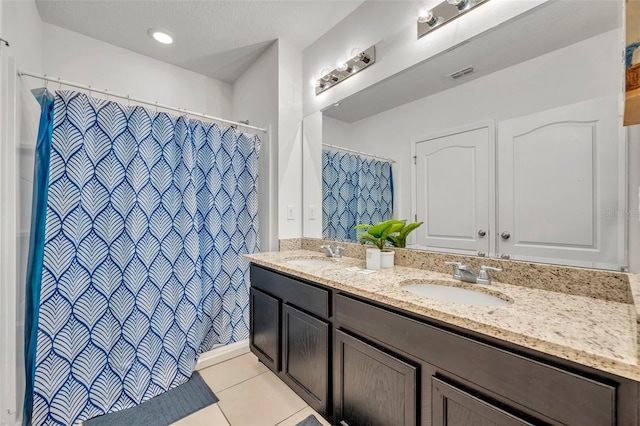 bathroom featuring tile patterned flooring and vanity