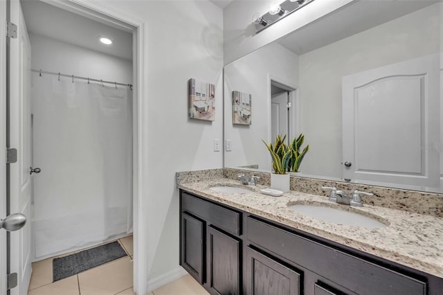 bathroom featuring vanity, tile patterned flooring, and curtained shower