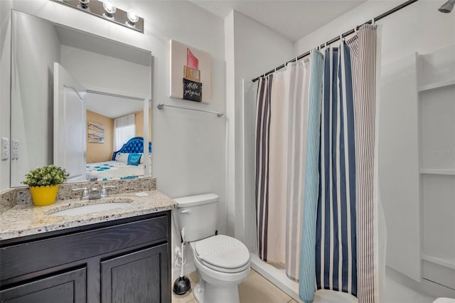 bathroom featuring toilet, vanity, tile patterned flooring, and walk in shower