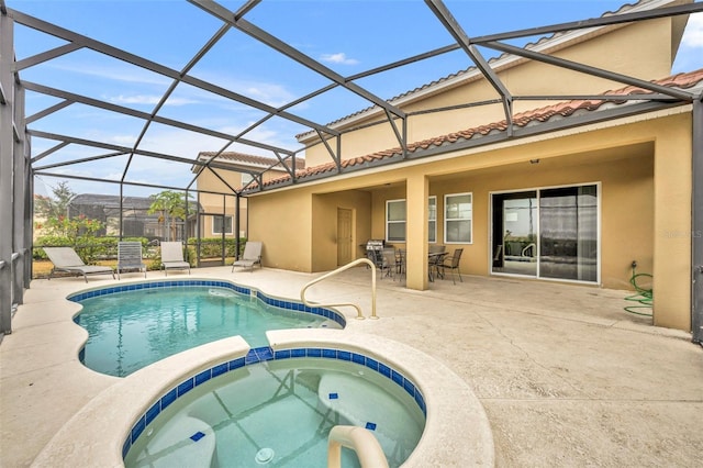 view of pool featuring a lanai, a patio, and an in ground hot tub