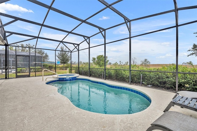 view of pool with glass enclosure, an in ground hot tub, and a patio