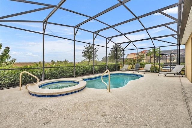 view of pool featuring an in ground hot tub, a lanai, and a patio area