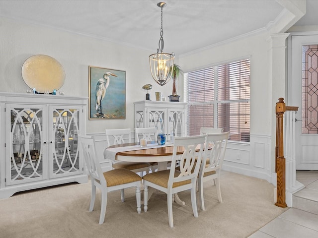 dining room with a notable chandelier, crown molding, and light carpet