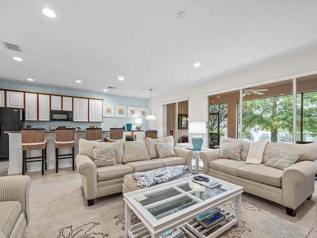 tiled living room featuring ceiling fan