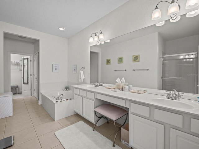 bathroom featuring tile patterned floors, vanity, and shower with separate bathtub