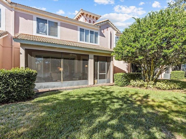 rear view of house with a yard