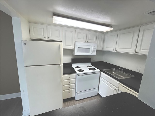 kitchen with sink, white appliances, and white cabinets