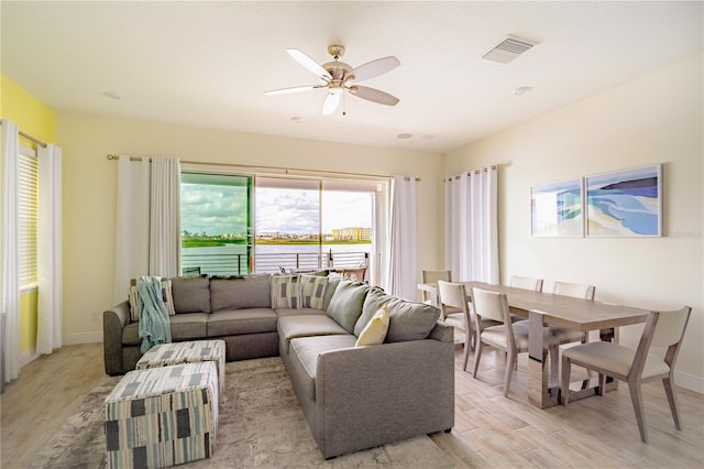 living room with light hardwood / wood-style floors and ceiling fan