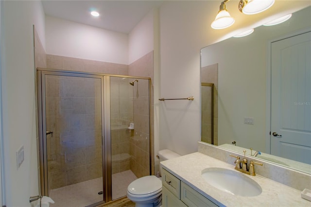 bathroom with vanity, toilet, and an enclosed shower