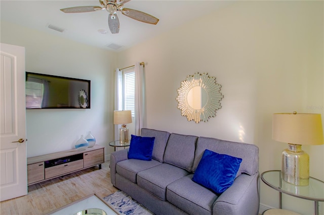 living room featuring wood-type flooring and ceiling fan