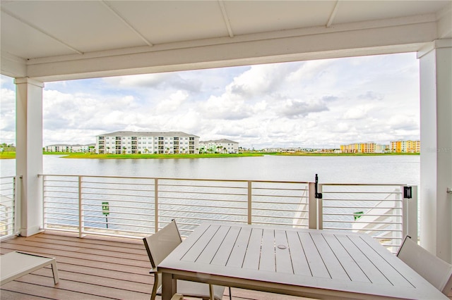 dock area with a balcony and a water view