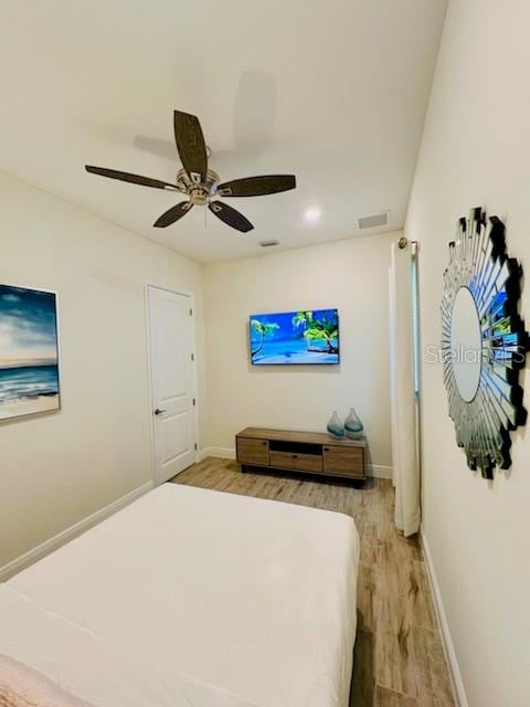 bedroom featuring ceiling fan and light hardwood / wood-style floors