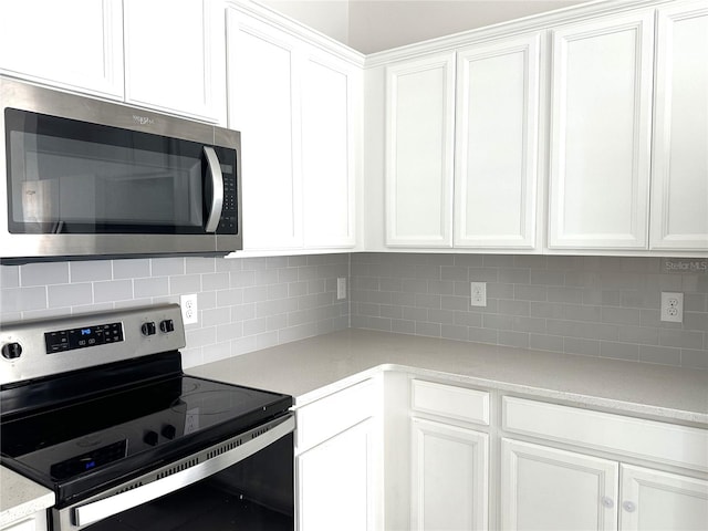 kitchen featuring white cabinetry, stainless steel appliances, and tasteful backsplash