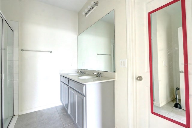 bathroom featuring a shower with door, vanity, and tile patterned flooring