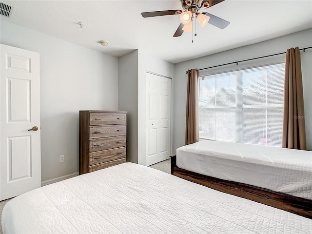 carpeted bedroom with a closet and ceiling fan