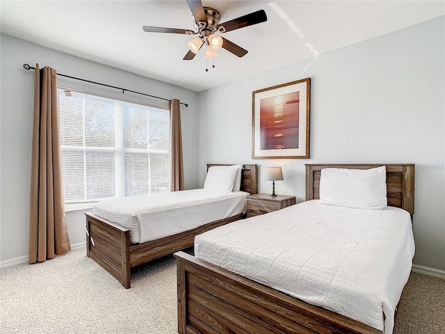 bedroom featuring light carpet and ceiling fan