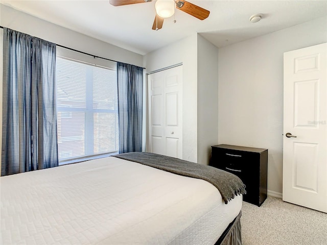 carpeted bedroom with a closet and ceiling fan