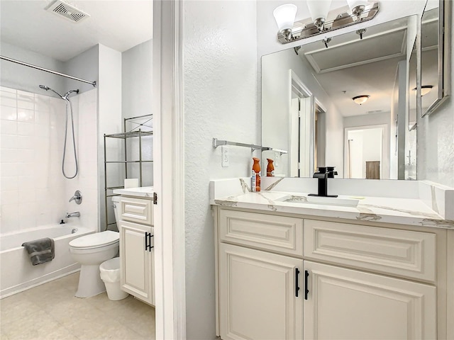 full bathroom featuring vanity, tile patterned flooring, tiled shower / bath combo, and toilet