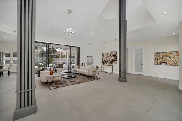 unfurnished living room featuring decorative columns