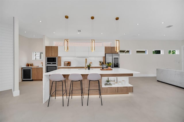 kitchen with hanging light fixtures, a large island, stainless steel appliances, and wine cooler