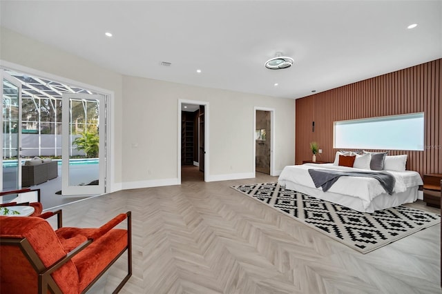 bedroom featuring multiple windows, light parquet floors, and access to exterior