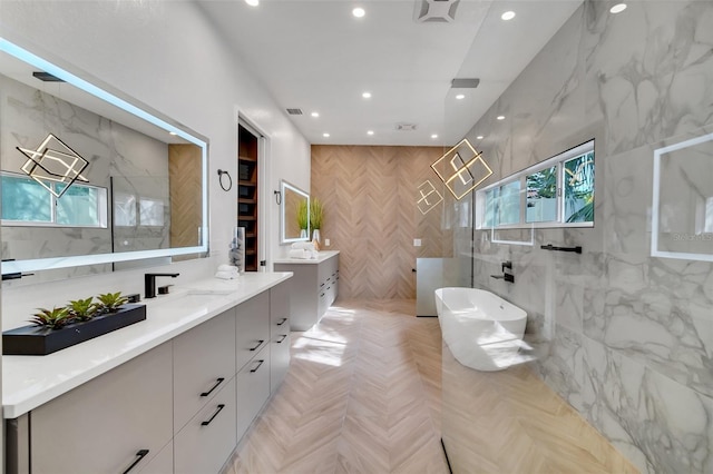 bathroom with vanity, plus walk in shower, parquet floors, and tile walls