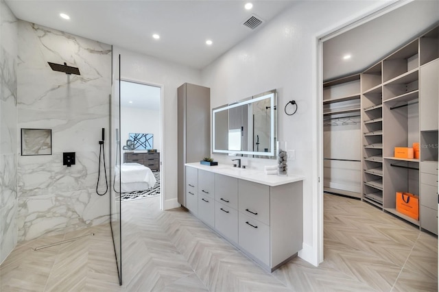 bathroom featuring vanity, a shower, and parquet floors