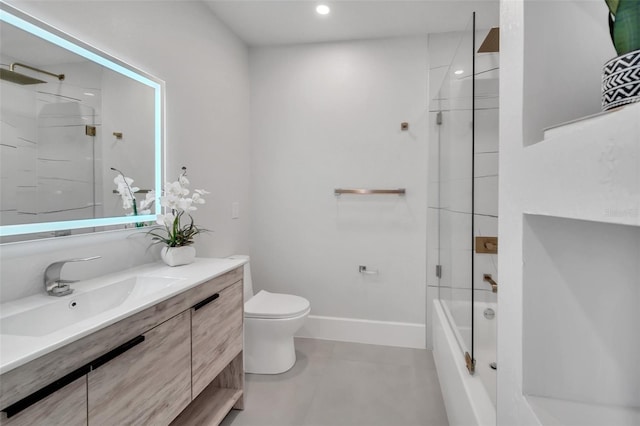 full bathroom with tiled shower / bath, vanity, and toilet