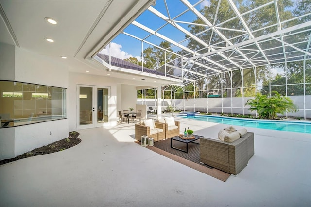 view of pool with glass enclosure, outdoor lounge area, a patio area, and french doors