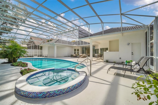 view of swimming pool with a patio, an in ground hot tub, and a lanai