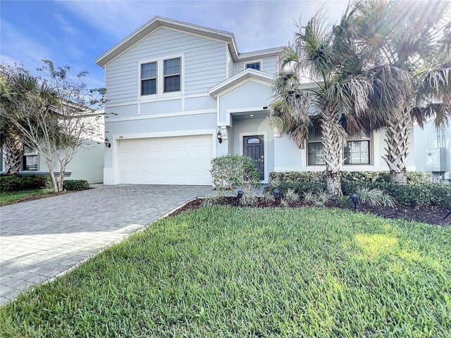 view of front of property featuring a front yard and a garage