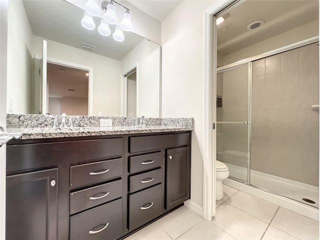 bathroom with tile patterned flooring, vanity, a notable chandelier, an enclosed shower, and toilet