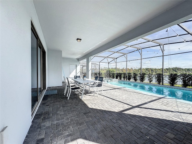 view of pool featuring a patio and glass enclosure