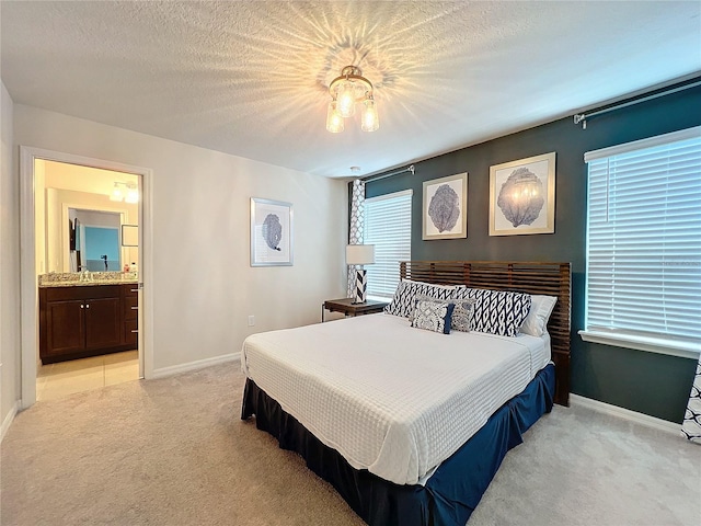 bedroom with multiple windows, light carpet, and a textured ceiling