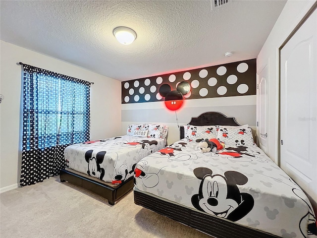 carpeted bedroom featuring a textured ceiling