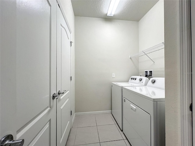 washroom featuring washer and clothes dryer and a textured ceiling