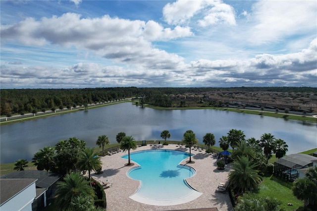 view of swimming pool with a patio and a water view