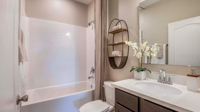 full bathroom featuring shower / washtub combination, toilet, and vanity