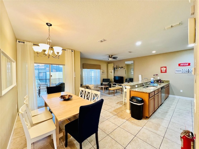 dining area featuring baseboards, visible vents, light tile patterned flooring, a textured ceiling, and ceiling fan with notable chandelier