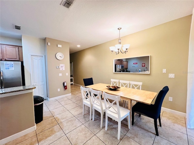 dining space featuring light tile patterned flooring, visible vents, and baseboards