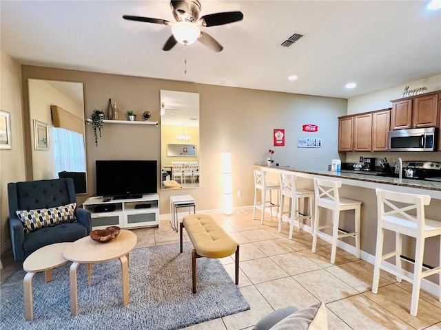 living room featuring ceiling fan, light tile patterned flooring, visible vents, and recessed lighting