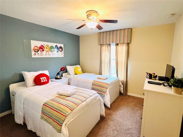 carpeted bedroom with a ceiling fan, a textured ceiling, and baseboards