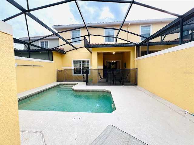 outdoor pool featuring a patio area and a lanai