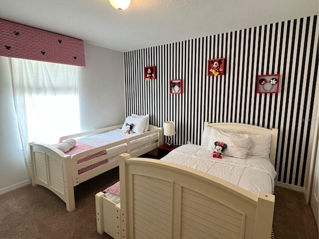 carpeted bedroom featuring baseboards and wallpapered walls
