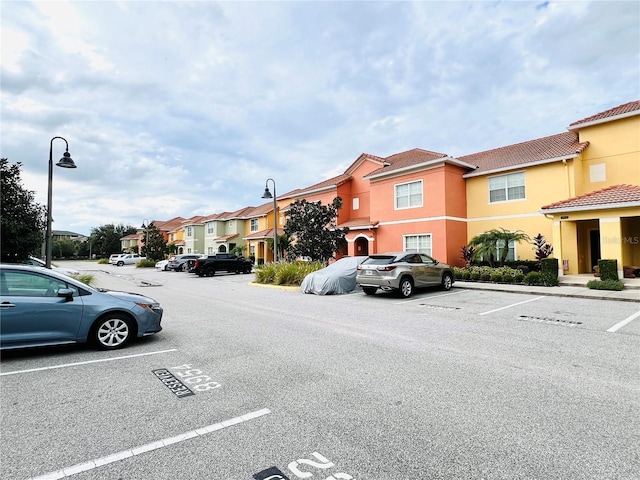 uncovered parking lot with a residential view
