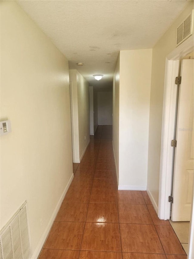 corridor featuring tile patterned floors