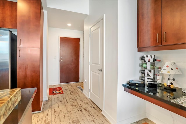 kitchen with stainless steel refrigerator and light wood-type flooring