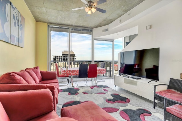 living room with a wall of windows and ceiling fan